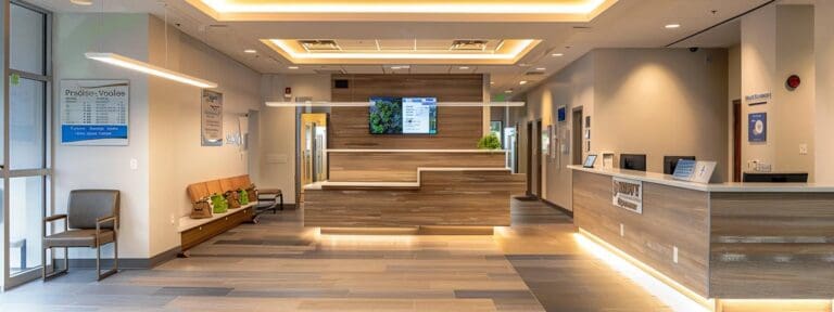 a sleek veterinary office with a modern reception area featuring a digital display screen providing clear information about pet health insurance enrollment, highlighting the theme of age limits and accessible insurance options.